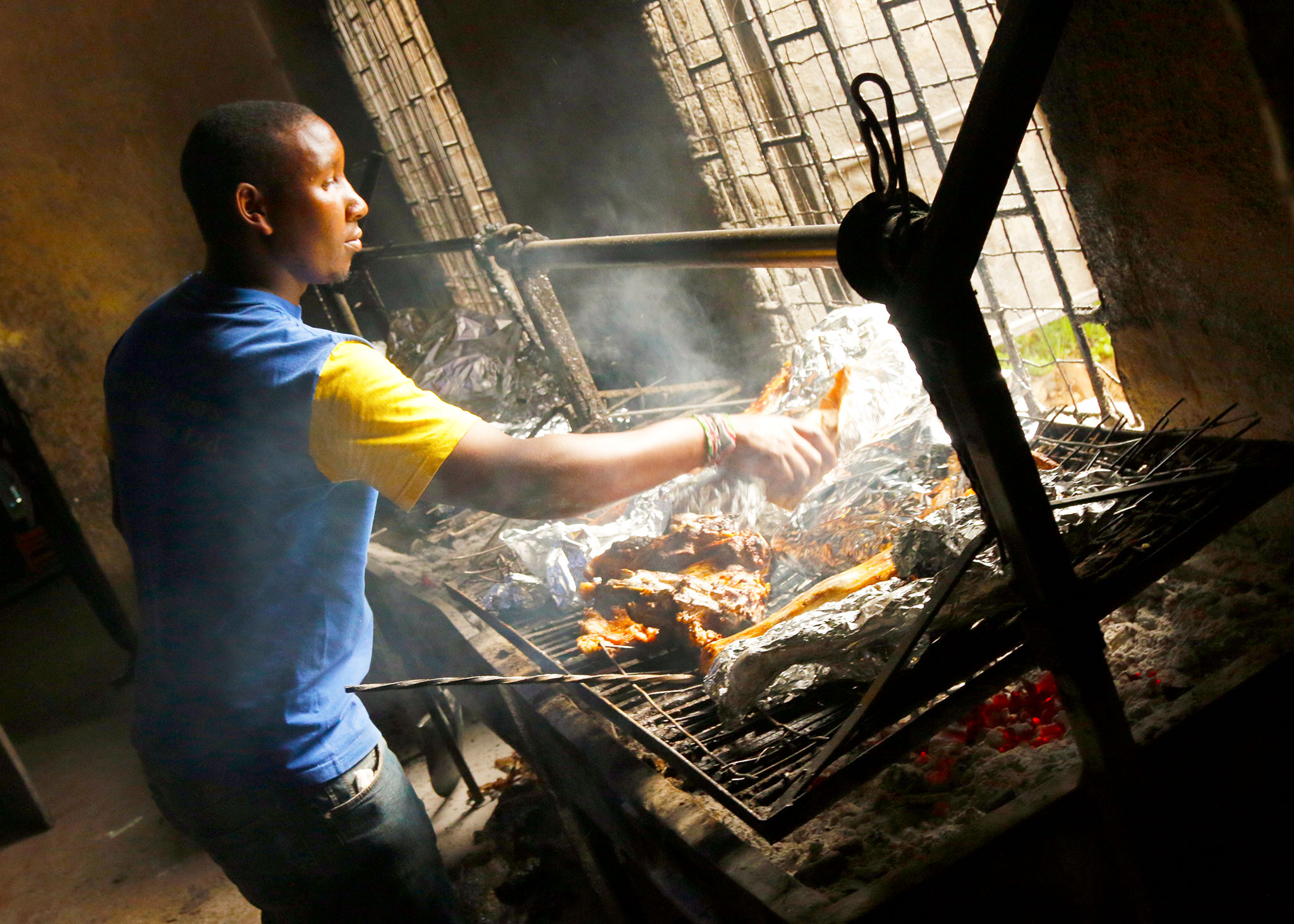 The meat is started directly on the grill, then transferred to a foil wrap to finish cooking.