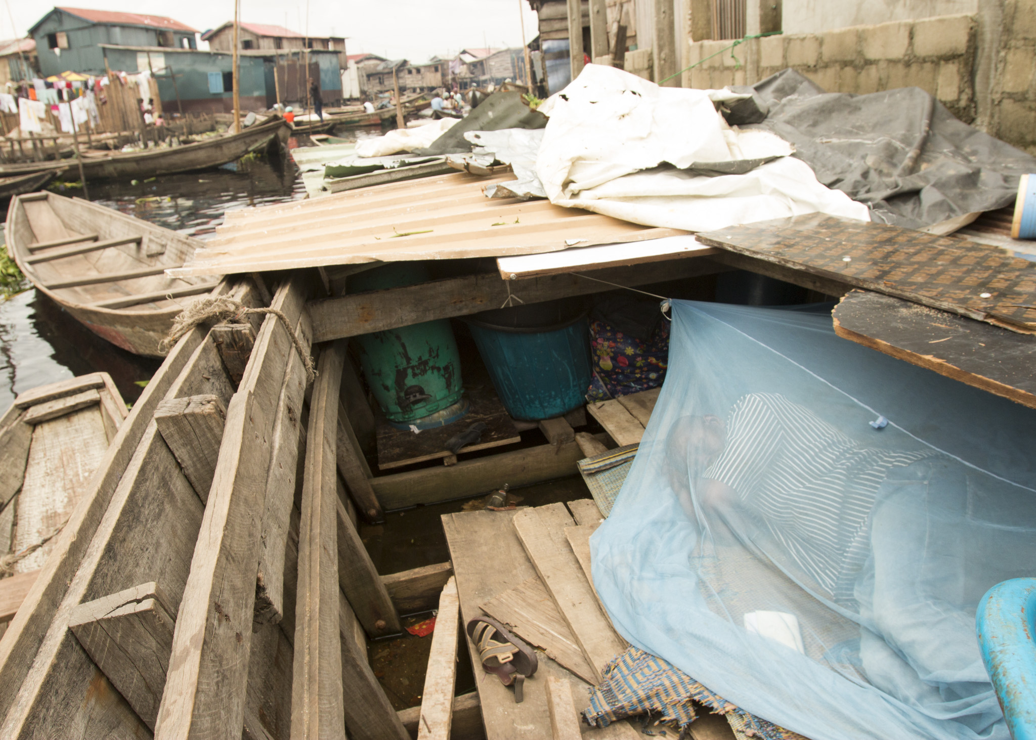 Salako Hunsa lives in a canoe in the Makoko waterfront settlement in Lagos, Nigeria. His home was burned down last month. (Tim McDonnell)