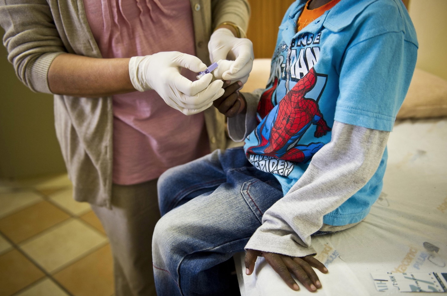 A staffer at the Right to Care AIDS clinic in Johannesburg administers an HIV test on a young boy. South Africa is one of the countries that receives funds from the U.S. President's Emergency Plan for AIDS Relief (PEPFAR). Gallo Images/Getty Images