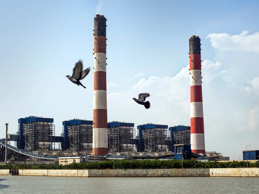 The coal-fired Tata Mundra power plant in western India was funded by a branch of the World Bank. A group of farmers and fishermen is suing, claiming that contamination of local water sources has disrupted their livelihoods. Sami Siva/International Consortium of Investigative Journalists