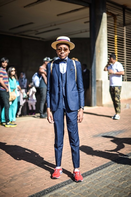 Although I’m not completely sold on pairing a suit with tennis shoes, this look sells itself. The added details of the three-piece suit and straw boater really bring up the appeal and make this ensemble a winner on and off the track. (From: blackfashion.tumblr.com )