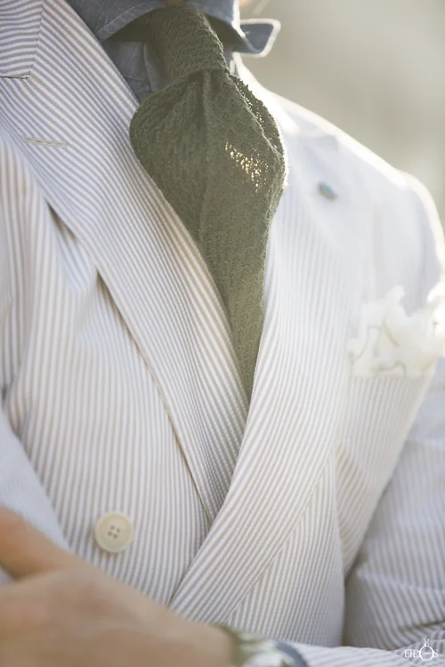 I love this twit on the traditional seersucker garb. The olive tie really makes the look. | From: thisisrome.net