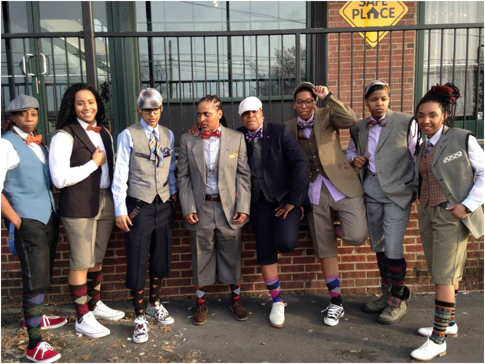 Fifth from left, designer E. Jaguar Beckford poses with models wearing Jag & Co