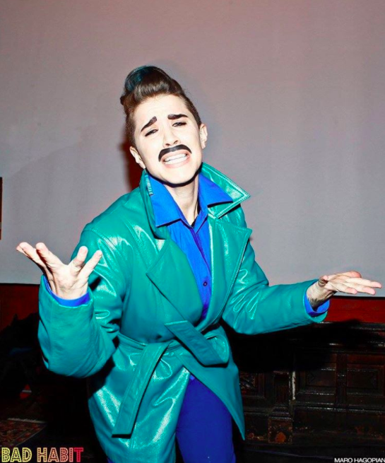 Goldie Peacock: "Brooklyn's golden boi! Award-winning drag king & movement artist. Drag workshop teacher, emcee, art model. They/them pronouns. Glamdrogyny! goldiepeacock.com "