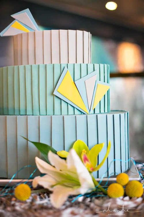 Oval cake with pleated fondant and handcut geometric sugar details. Image © Alante Photography