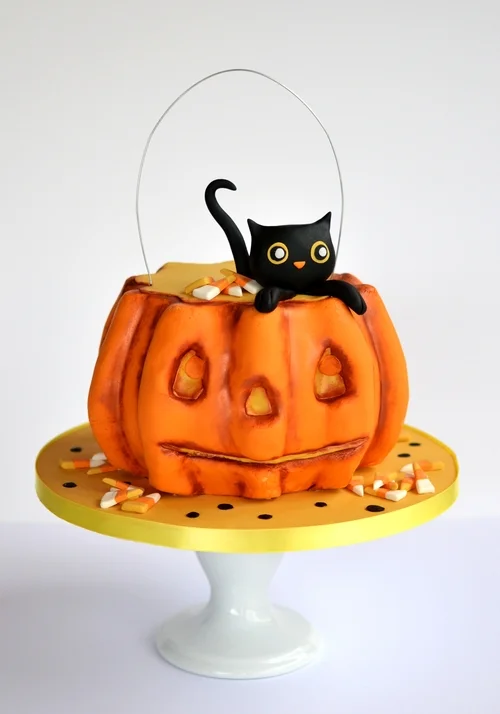 Carved pumpkin cake with sugar kitty and fondant candy corn. Image © Carla Schier