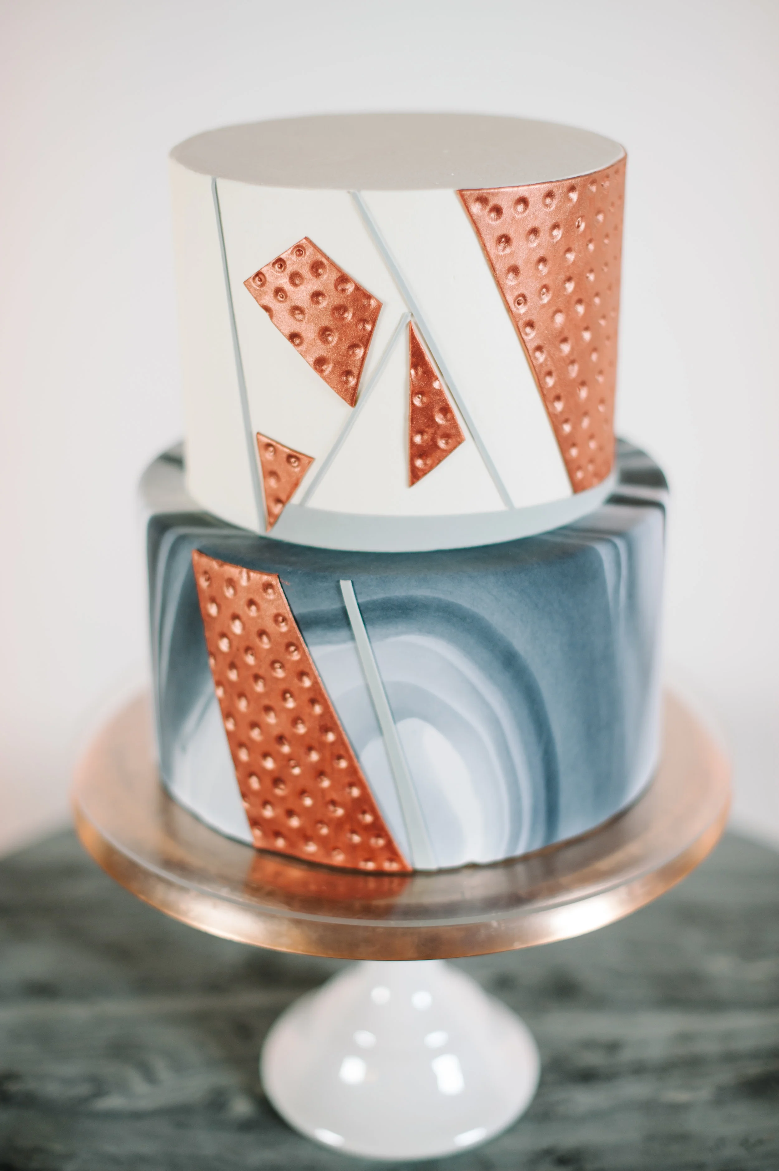 Marbled cake with edible hammered copper and geometric details. Image copyright Blue Rose Photography.