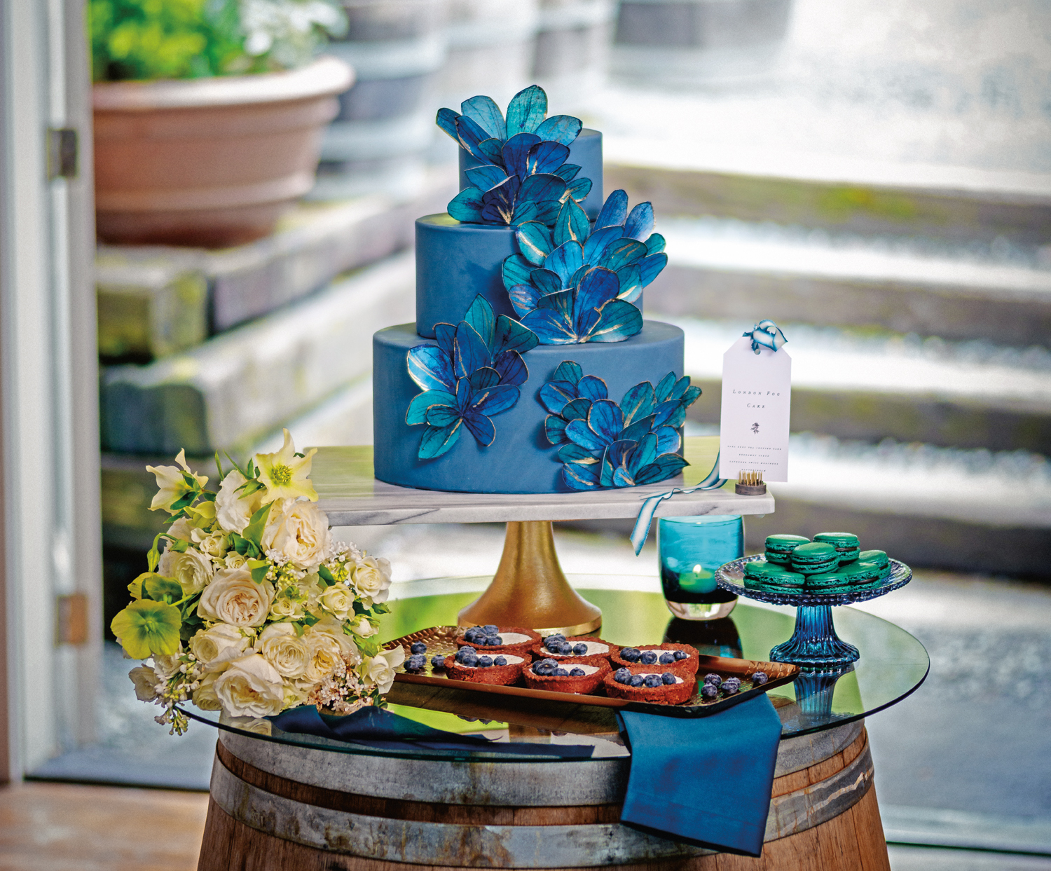 Hand-painted and gilded edible paper petal cake with custom macarons and tartlets. Image copyright Nick Pironio Photography for Seattle Met Bride & Groom.