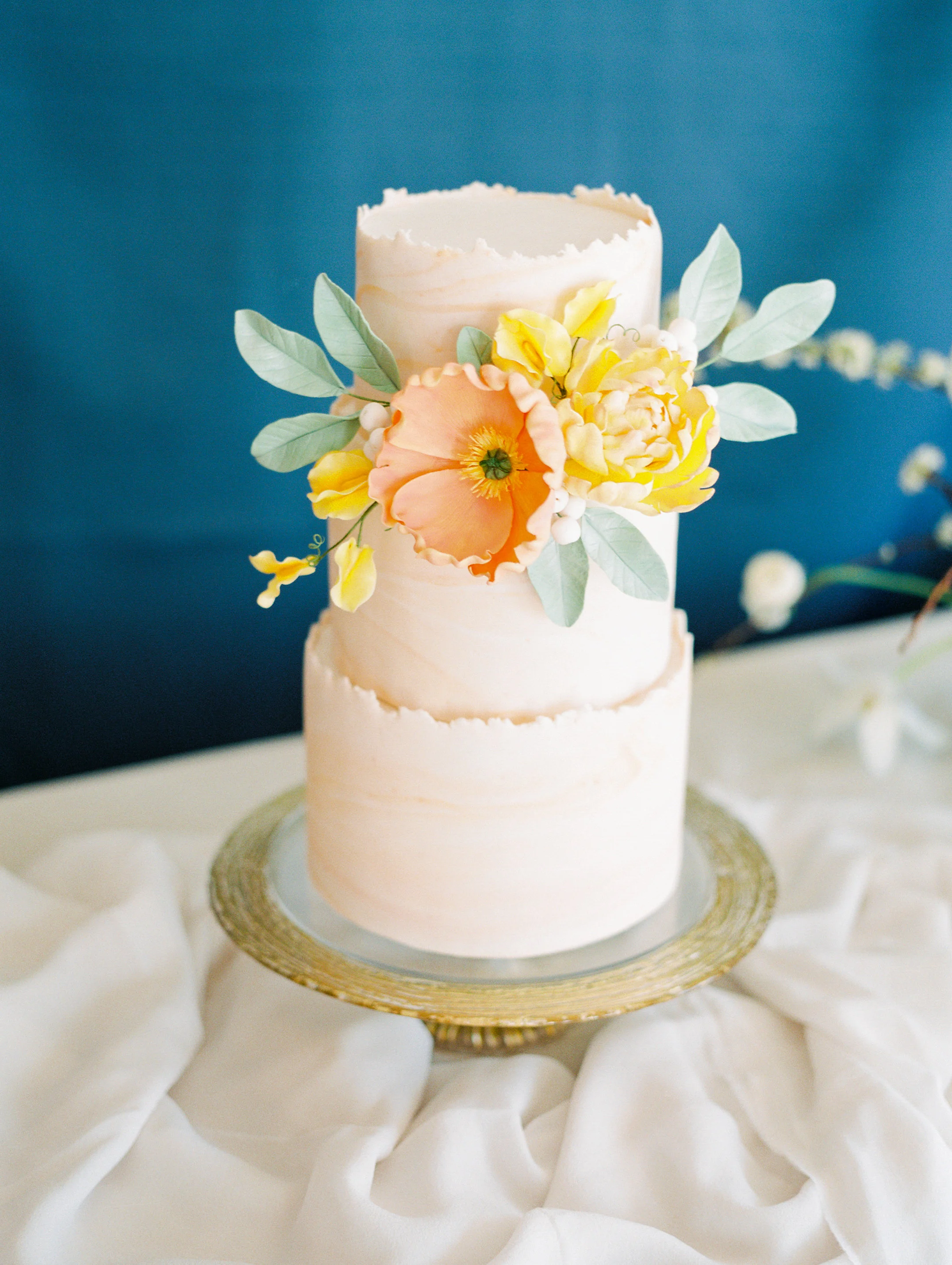 Marbled torn-edge cake with sugar flowers. Image copyright Gabriela Ines Photography