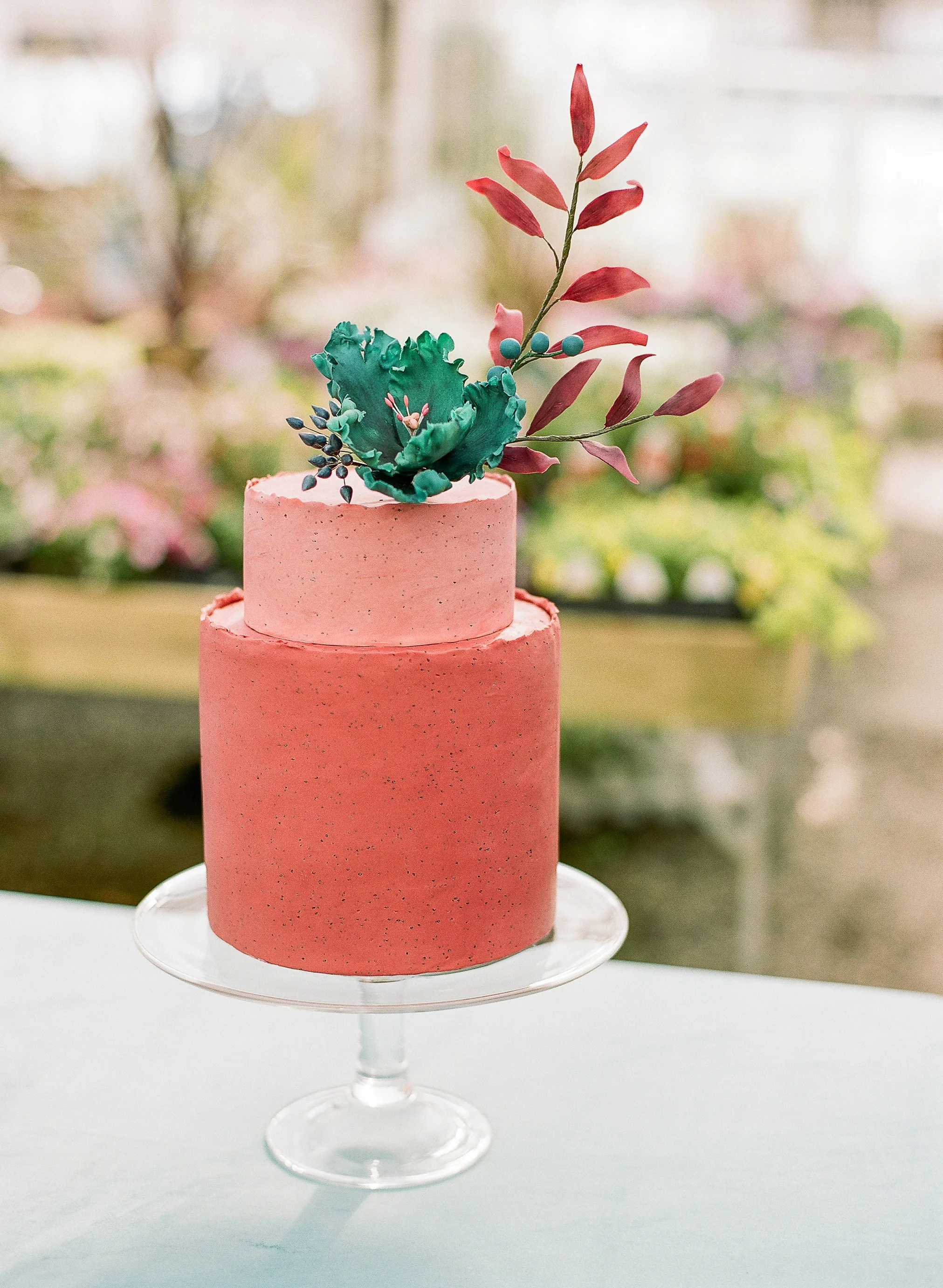 Terracotta and coral cake with sugar flowers. Image copyright The Ganeys