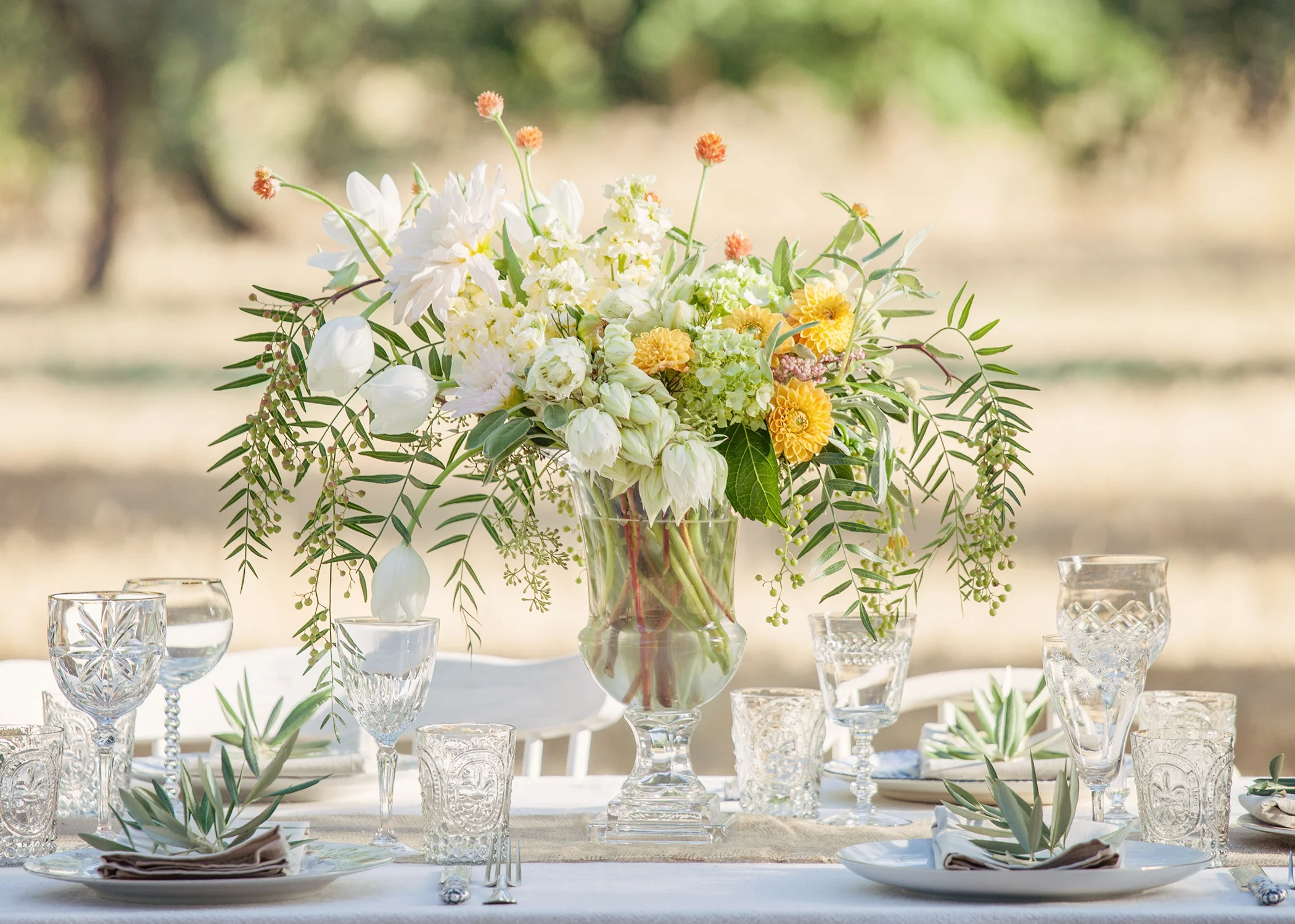 These summer flowers were selected in bright but soft hues to compliment the silver in the olive branches and golden grasses.