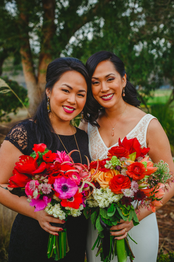 Claire (Maid Of Honor) and Aggie (Bride) carried jewel tone bouquets featuring winter blooms of amaryllis, ranunculus, anemone, narcissus, chocolate cosmos, jasmine, chocolate, Queen Anne's lace, geranium, and scilla white Havana lily.