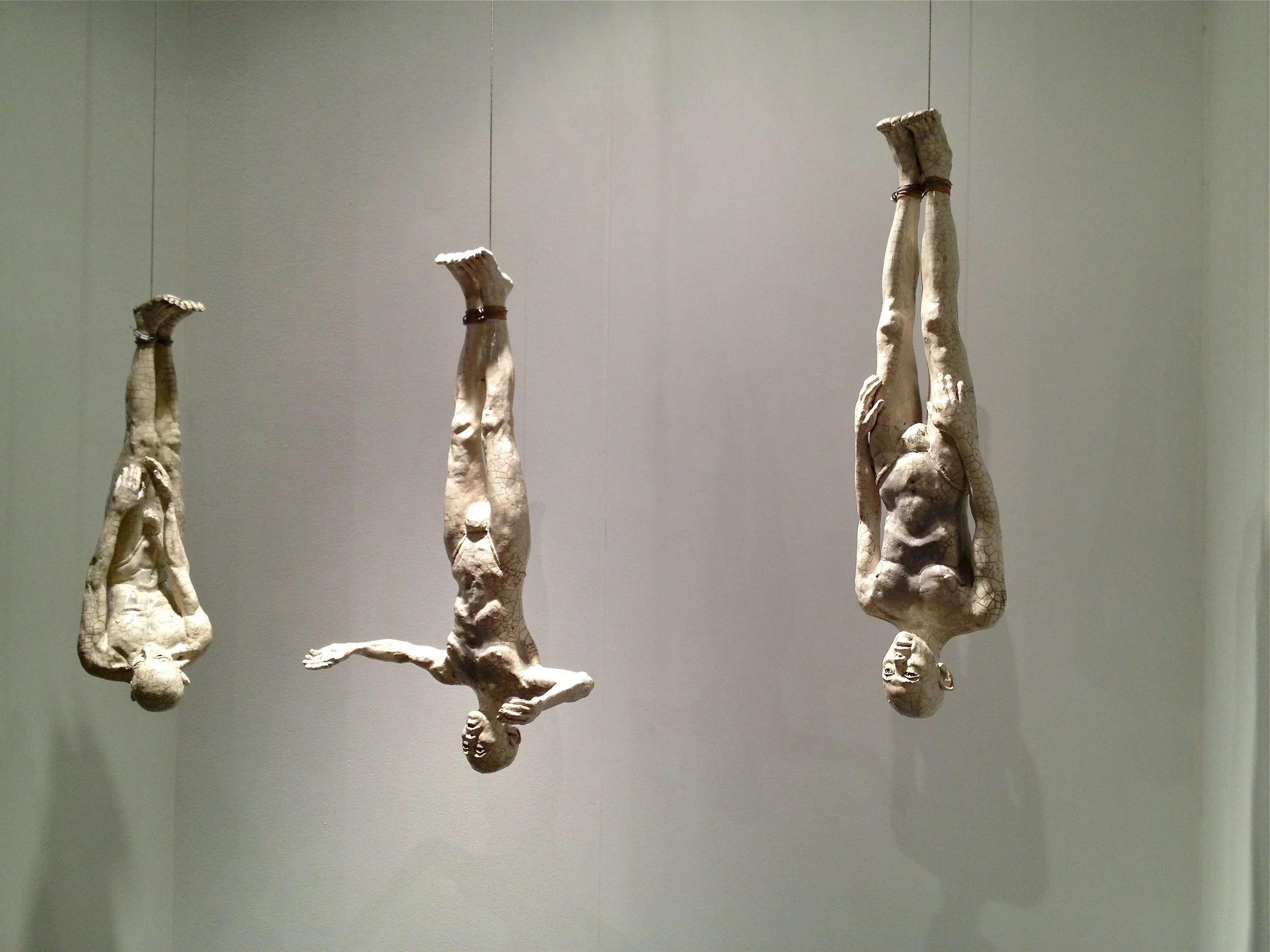 Three Hanging Butoh Figures (v3) 34"H figures, raku-fired stoneware, steel cable
