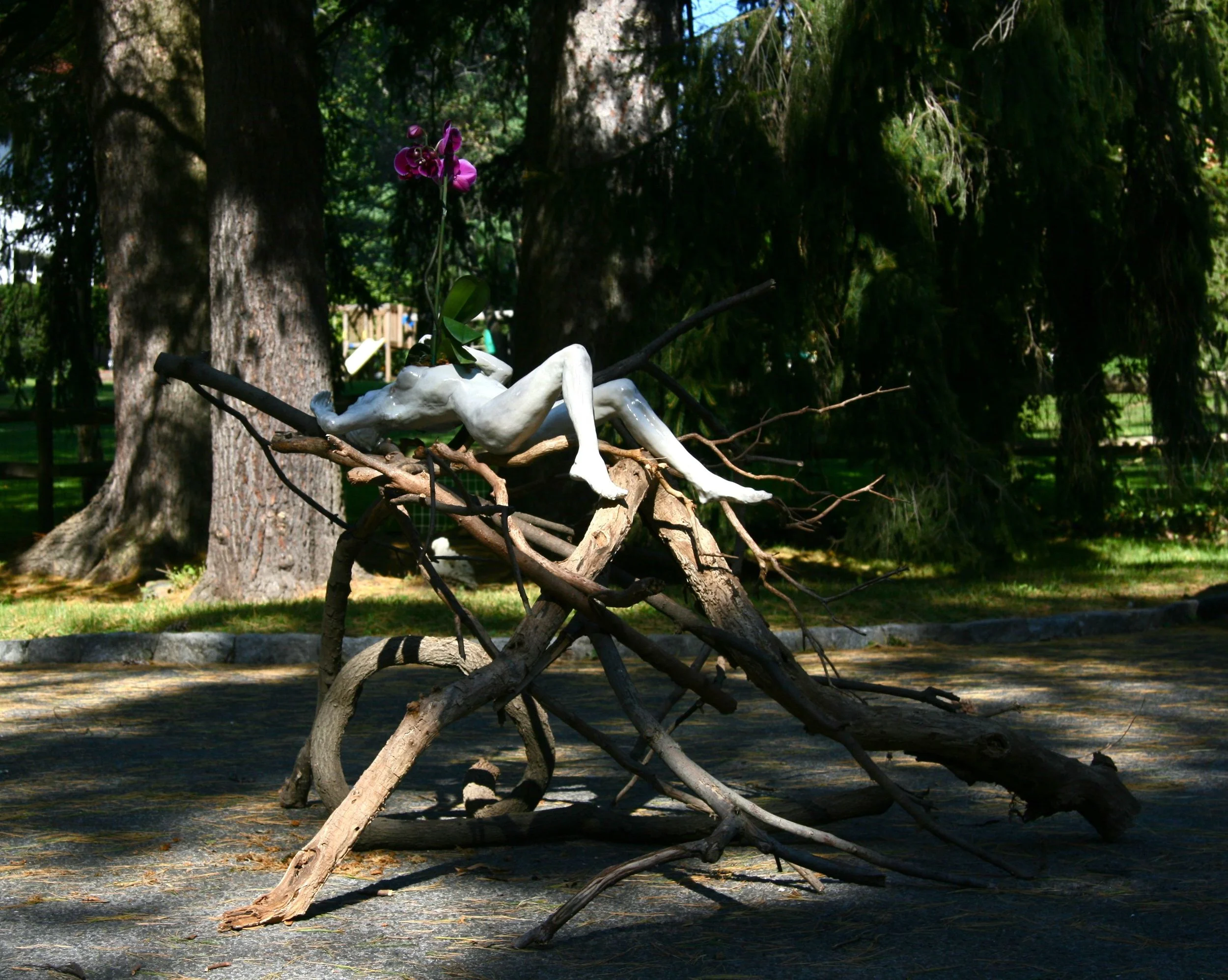Woman with Orchid, on branches, installation view, 5'x6'x40"H, raku-fired stoneware, branches, orchid