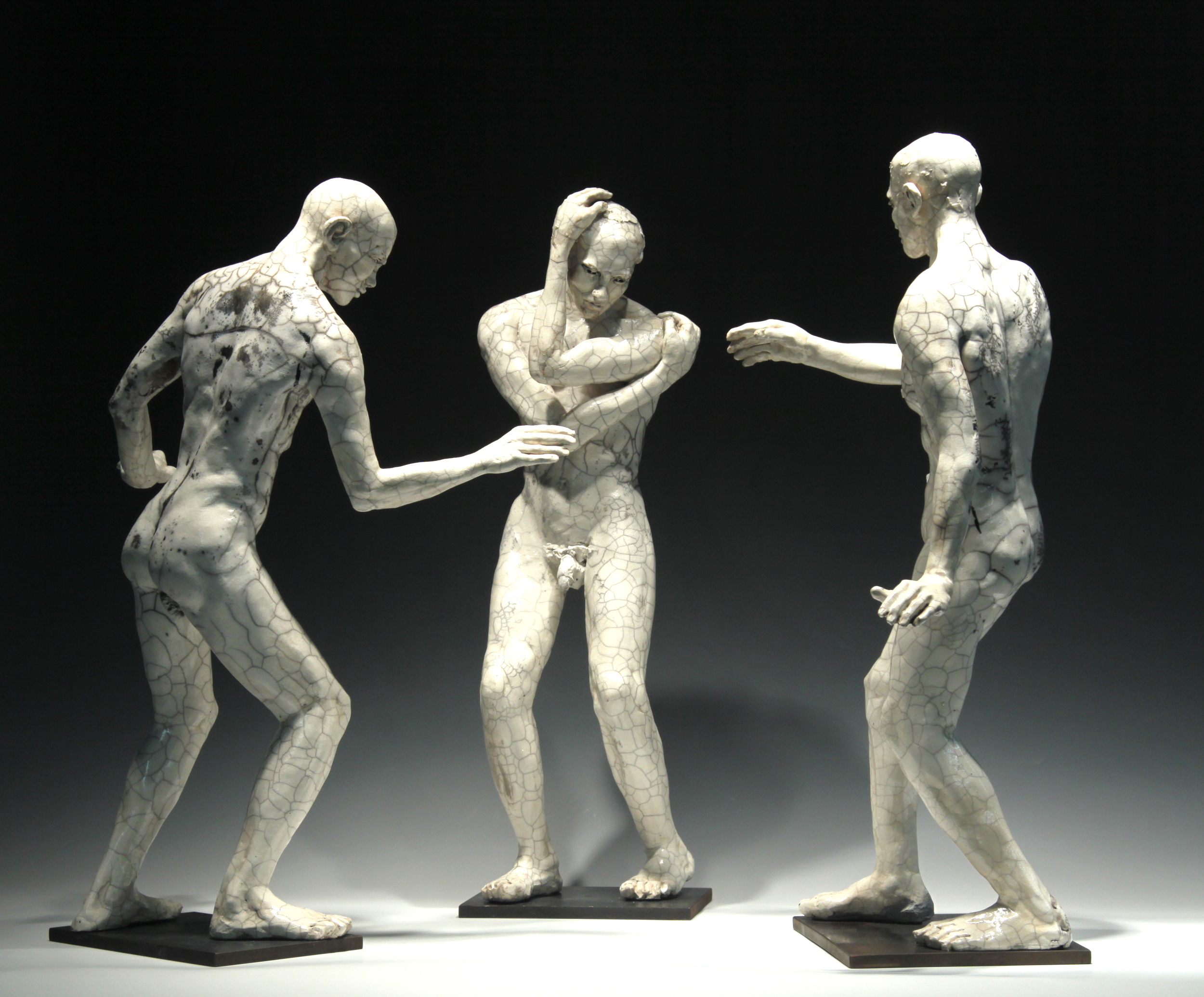   Three Male Figures  (installation view) 23"H, raku-fired stoneware 
