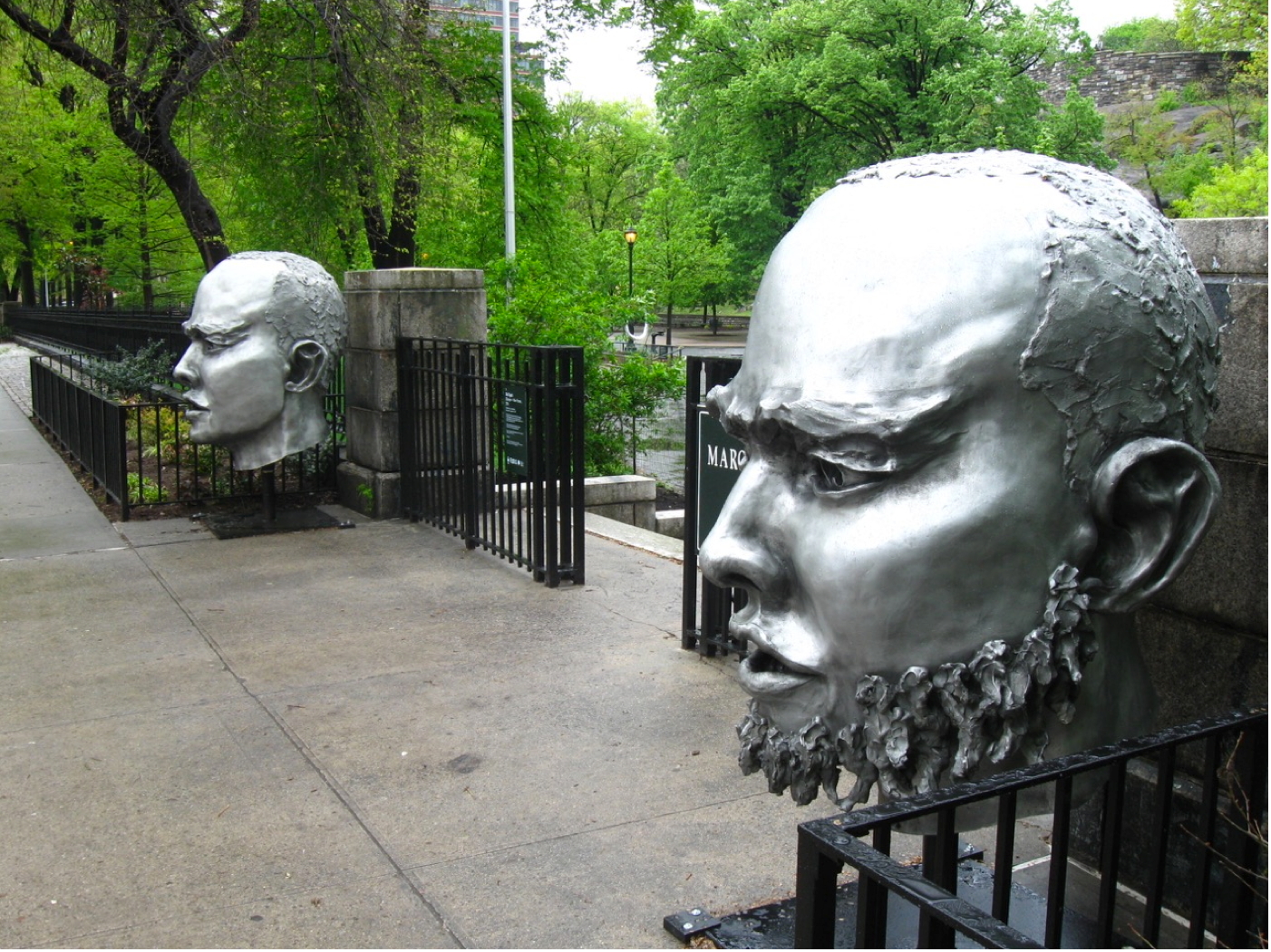 (E)scape New faces public art Head sculptures installed outdoors at Marcus Garvey Park, Harlem NYC. Photo Courtesy Hyperallergic. They engage the community in a dialog with art, an aspect of art social practice outreach art in a community of color. This is inspired by the work of such artists as Theaster Gates and Nick Cave.