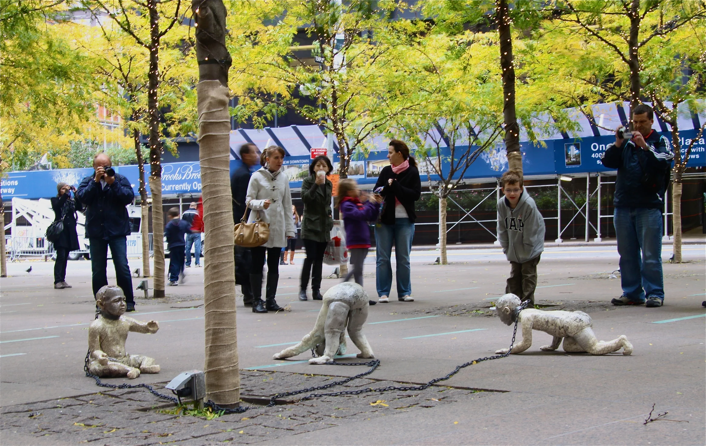 Treasury Bondage installed in Zuccotti Park in Manhattan's financial district, 2010. Raku-fired stoneware lifesize figures, steel, chain.