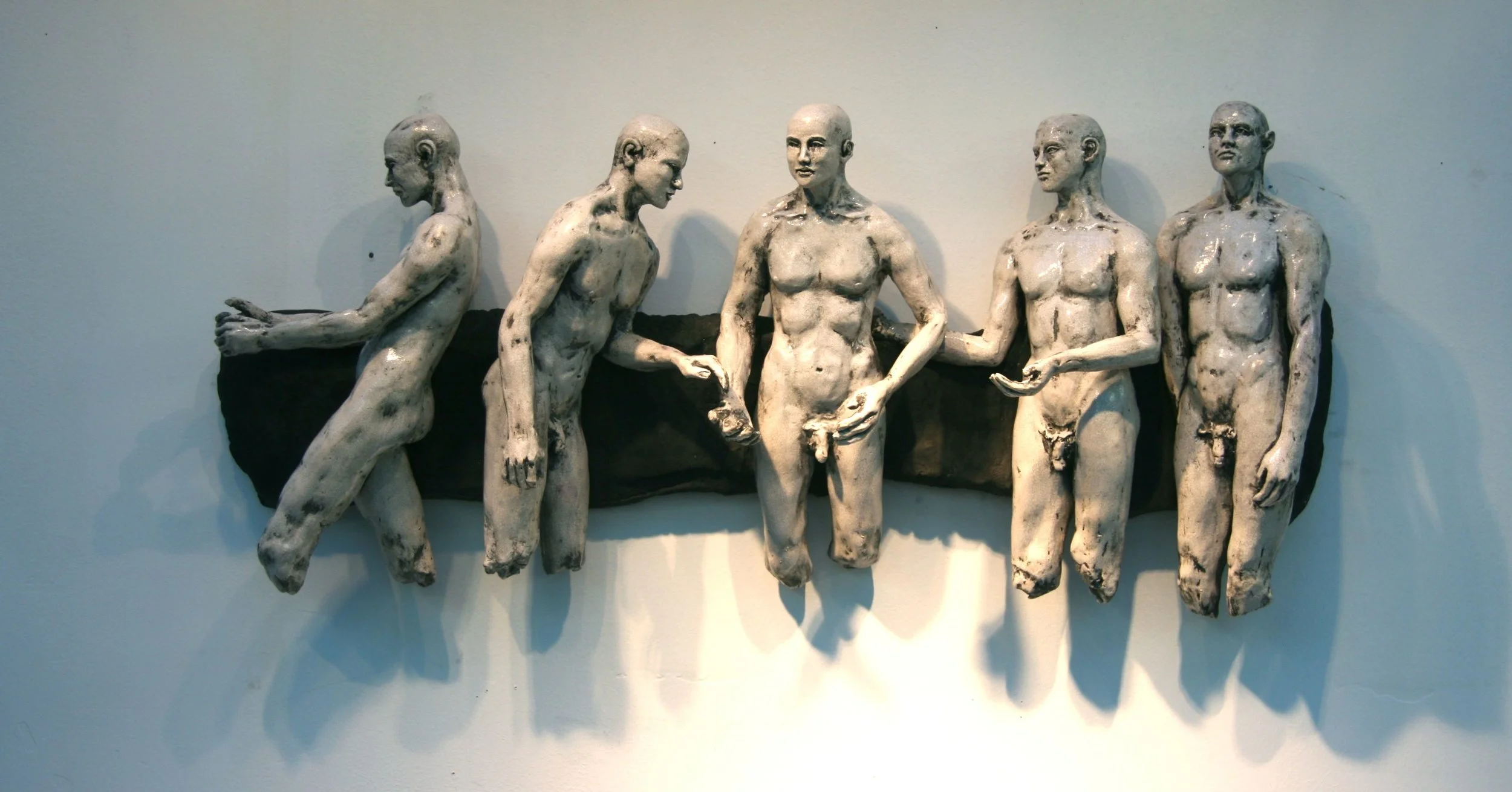  A relief of multiple figures like this one could be created in the appropriate size for this wall.  This piece is about 32” wide by 15” H 