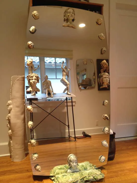 Available, glazed ceramic heads mounted on custom cut mirror, 60”H 