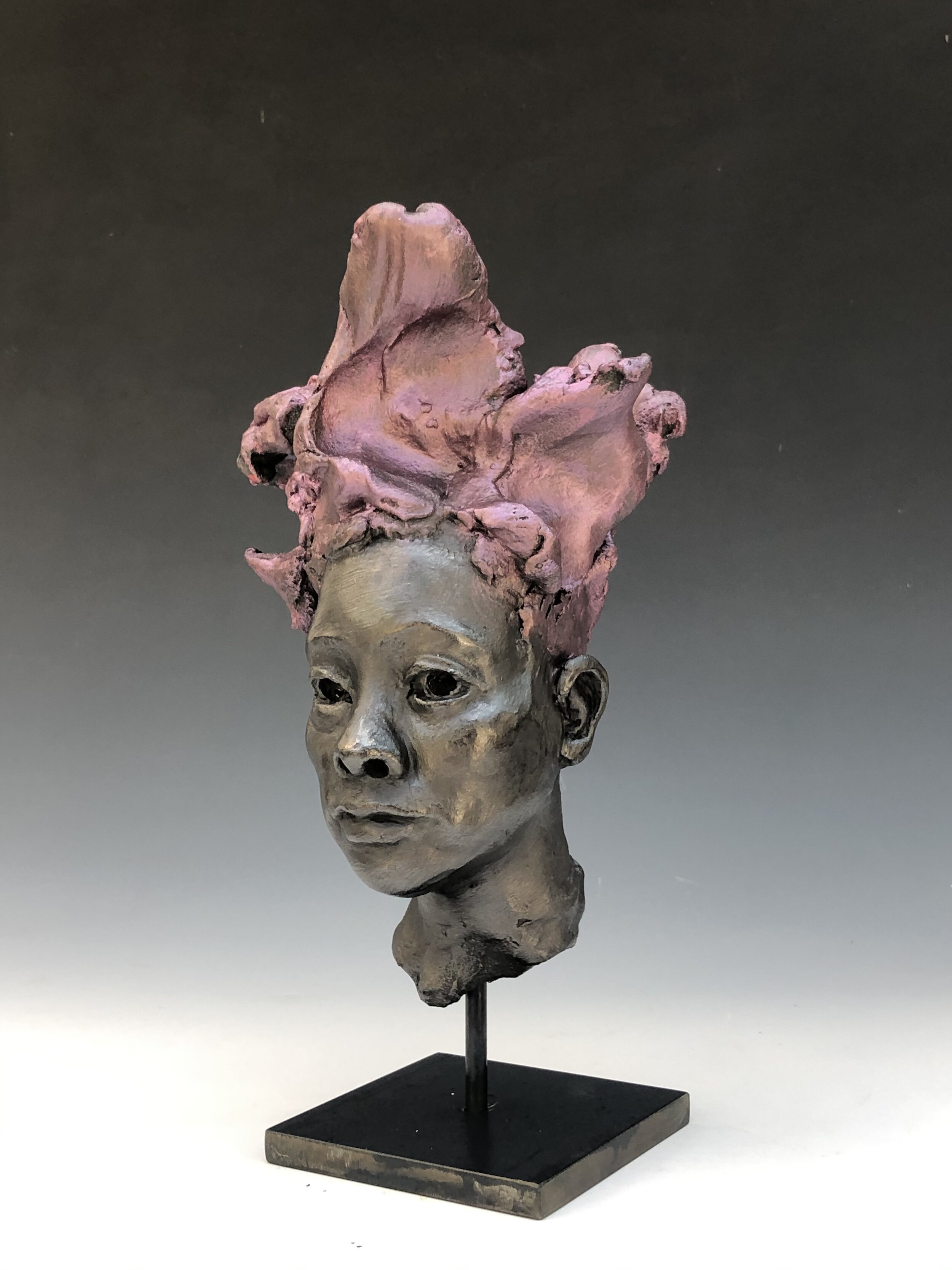  Small stoneware head with metal patinas 