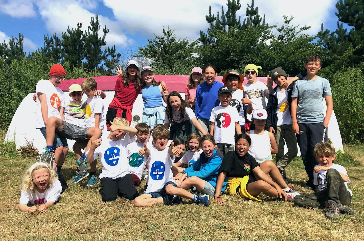 Children laughing and having fun at Camp Kernow off-grid summer camp in Cornwall UK