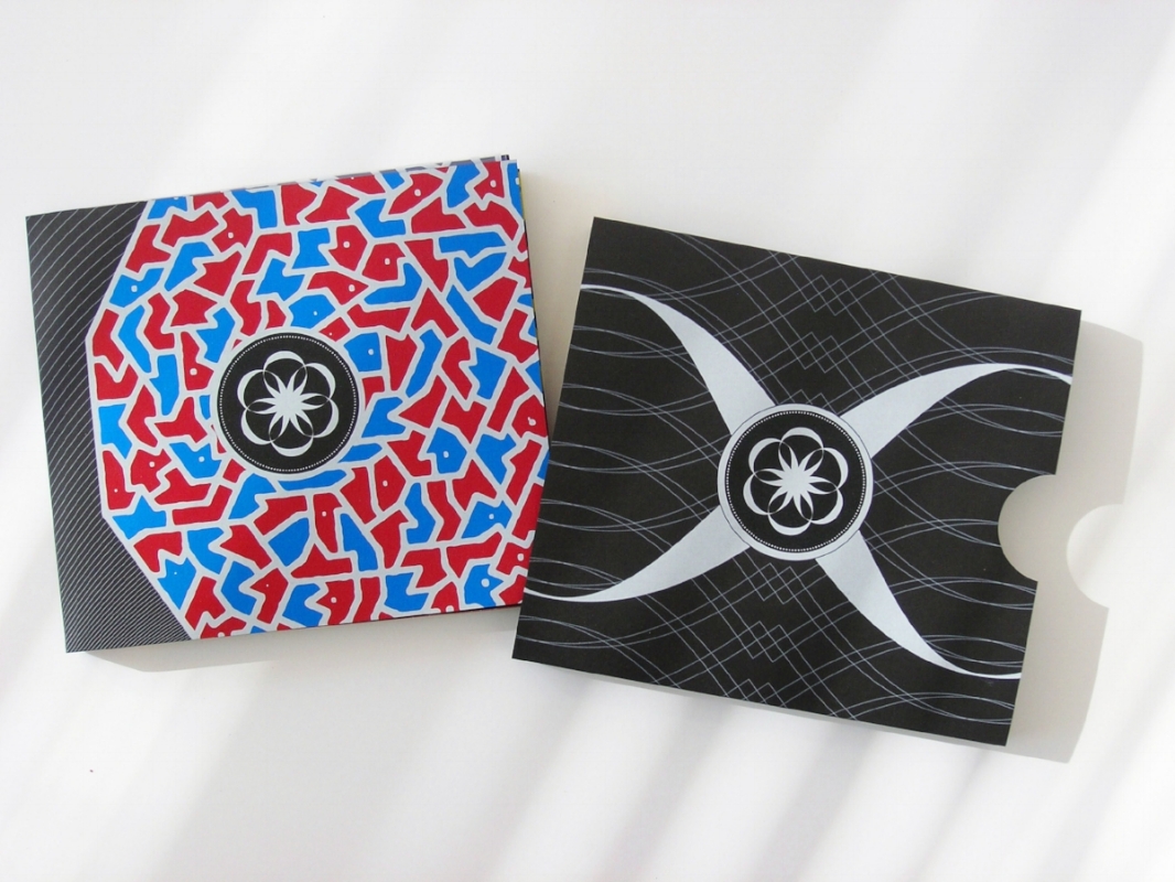 Front cover and folder case of the book, printed in red, blue, yellow and white on a black uncoated paper