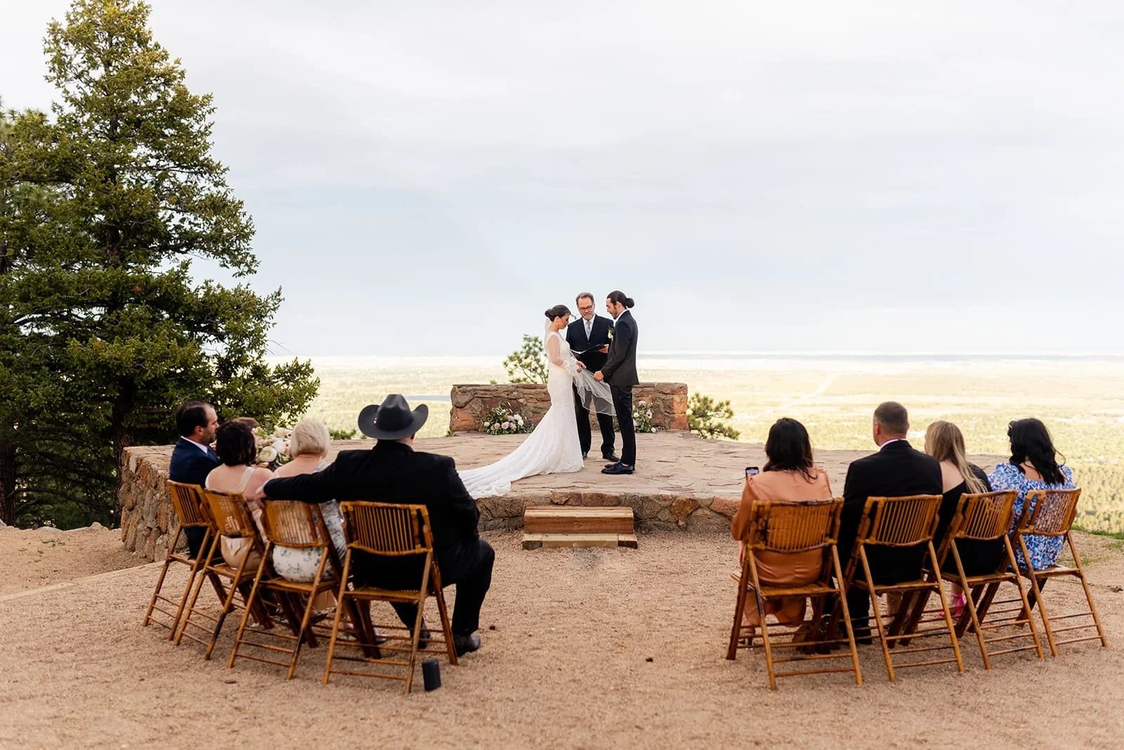 A Sunrise Amphitheater ceremony with the couple onstage and guests seated in wooden chairs in the inner circle.
