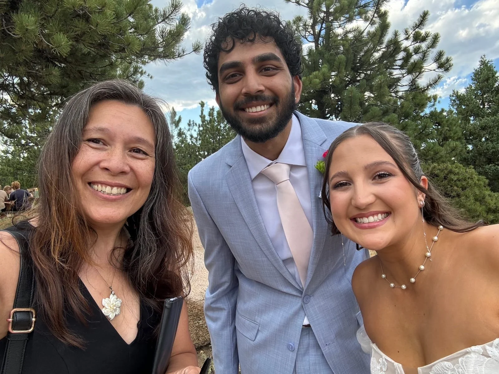 Officiant Lisa taking a smiling selfie with a couple who just eloped