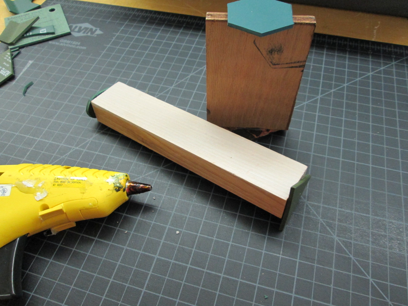 Hot gluing them on to extra wood samples to create a handle for the stamp