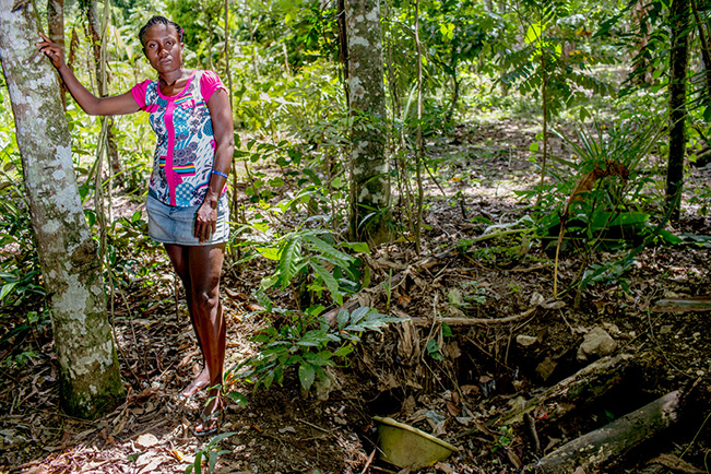 Martine stands besides her "toilet" near her home in Haiti. Martine is a part of the 33% of the world population without access to adequate sanitation. Image: Shiho Fukada, My Toilet exhibit 