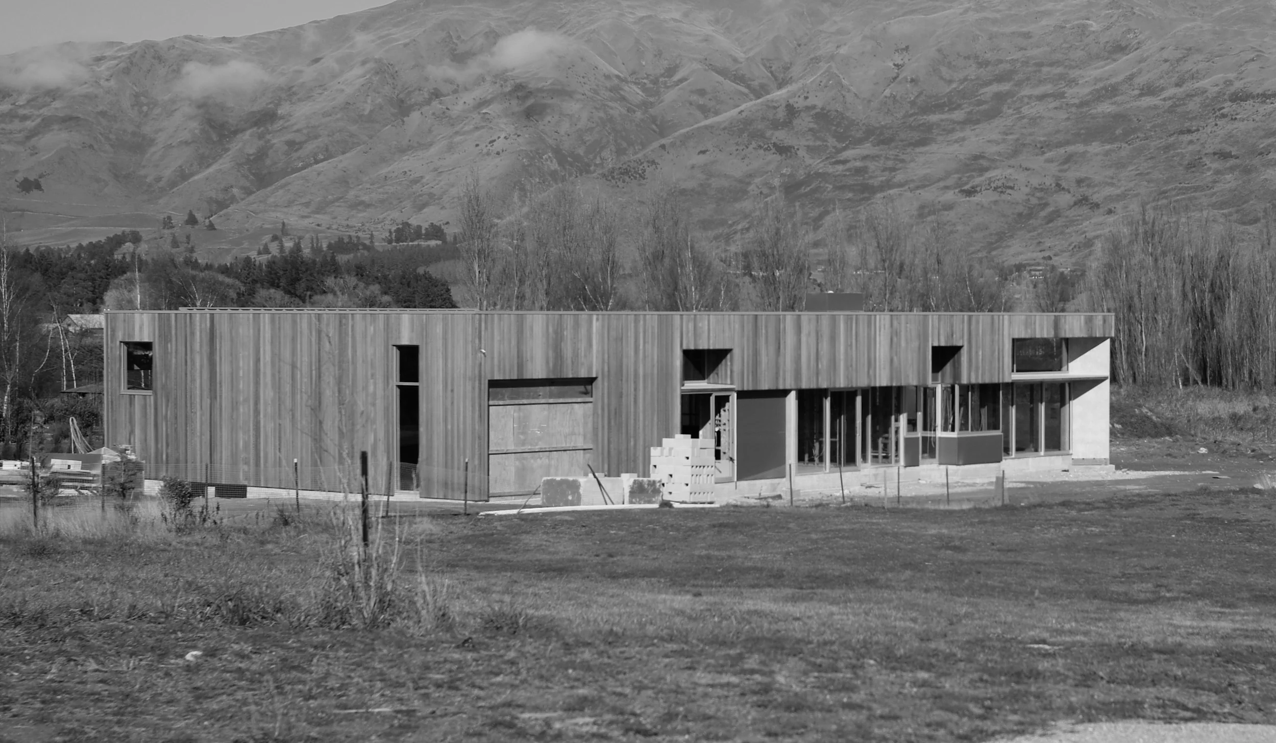 Wanaka Bach with opaque "party wall" progressively eroded towards outer corner and views.