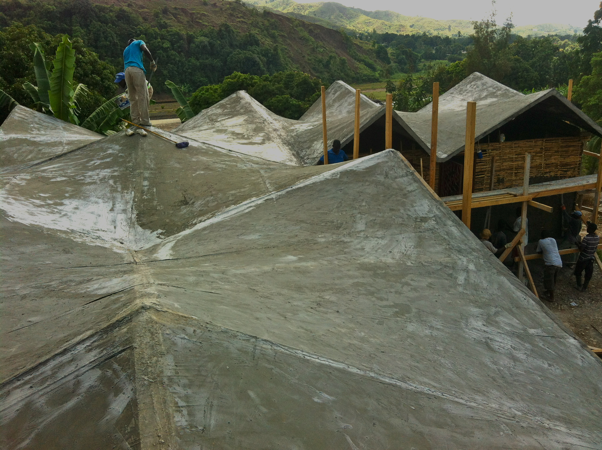   The roof utilizes the strength of hyper-parabolic forms (think Pringles chips) for an efficient structure made&nbsp;of fiberglass bug screen and painted on cement mixed with acrylic. It's repairable, and light weight at less than a 1/2" thick.&nbsp