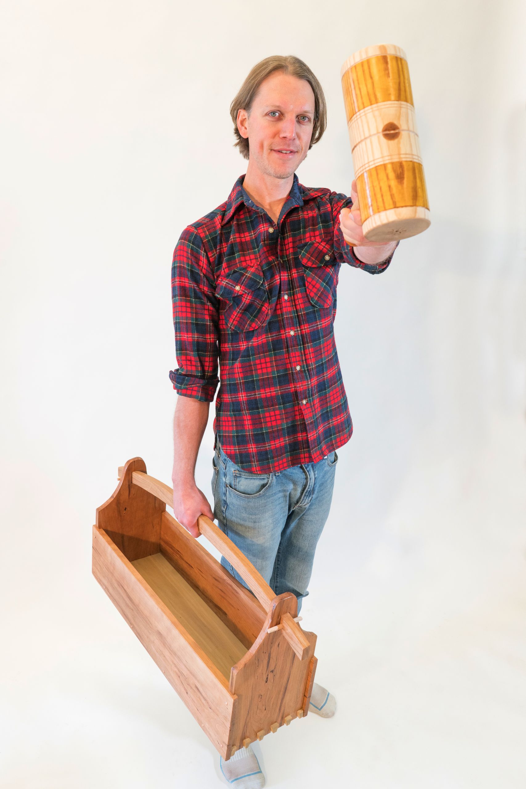 Tool tote in one hand and turned mallet in the other, Corey White