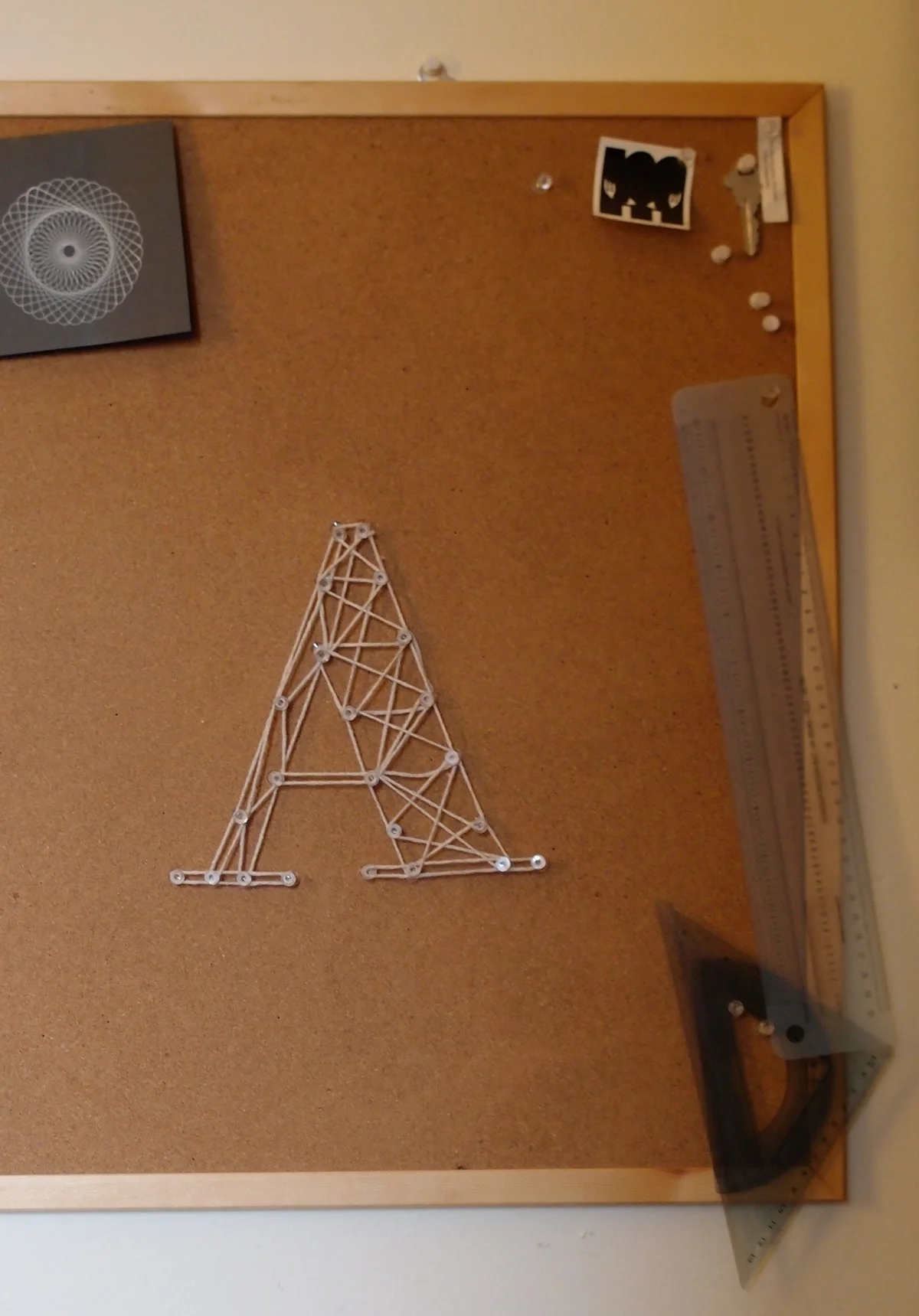     May 11:   Cleared off my bulletin board and made this A using tacks and string.  