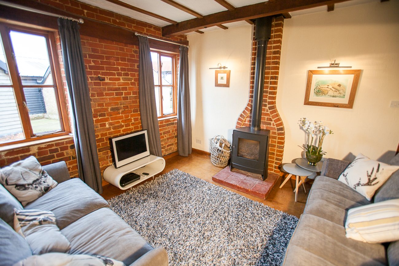 Lounge with two 3 seater couches and wood burner TV with broadband internet