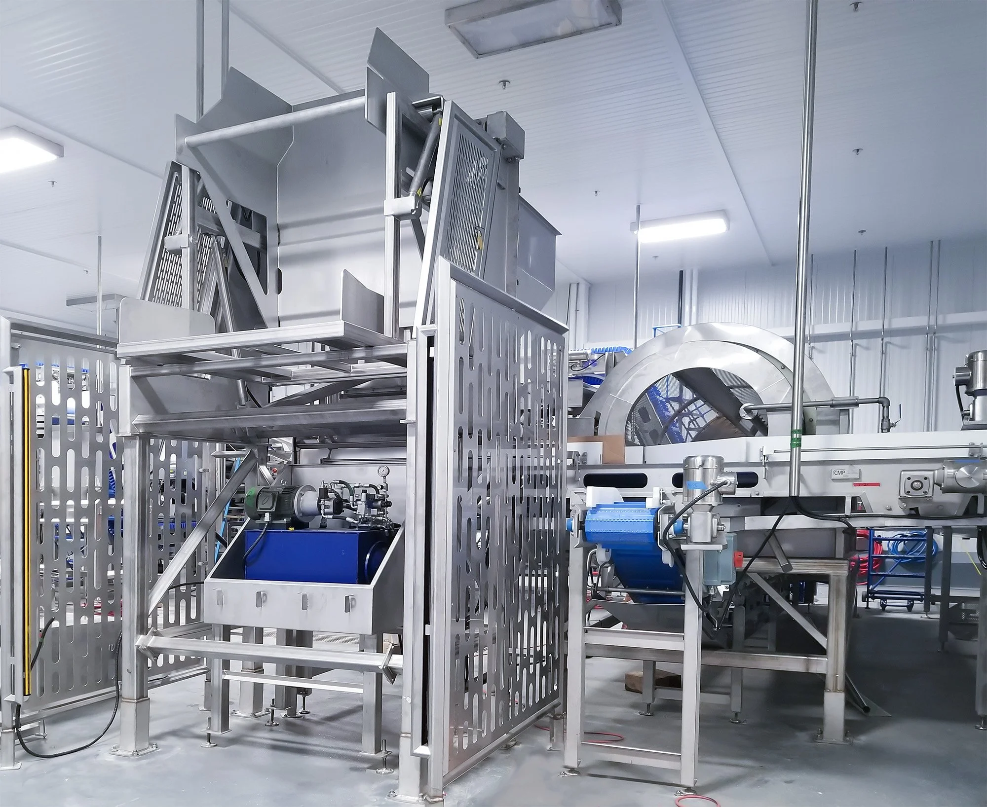Industrial machinery and metal framework in a clean, well-lit room, that is part of FPS Food Process Solution's end-to-end blueberry processing line.
