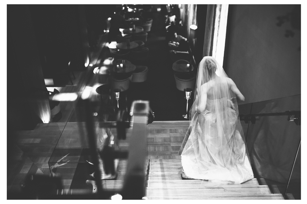 Bride walking down the stairs at Four Seasons Toronto.