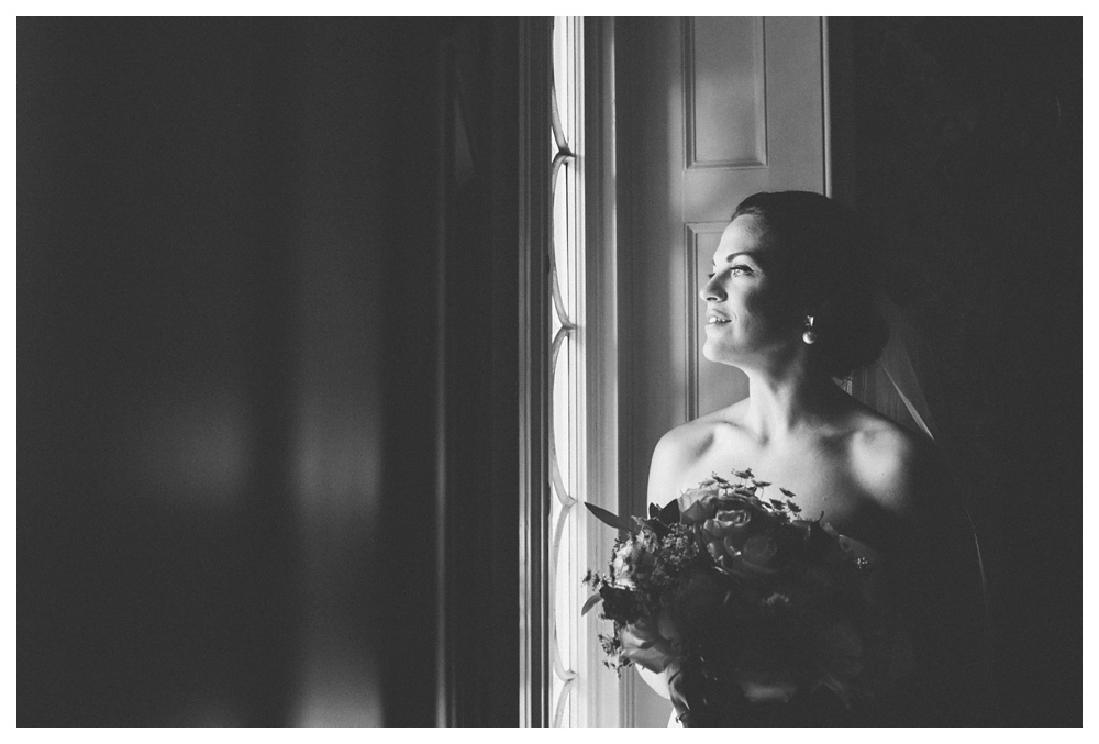 Bride looking out the window at the Briars on her wedding.
