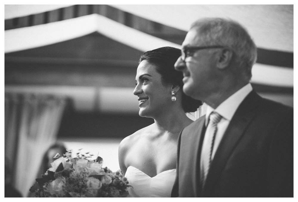 Emotional bride walking down the aisle with dad at the Briar for wedding.