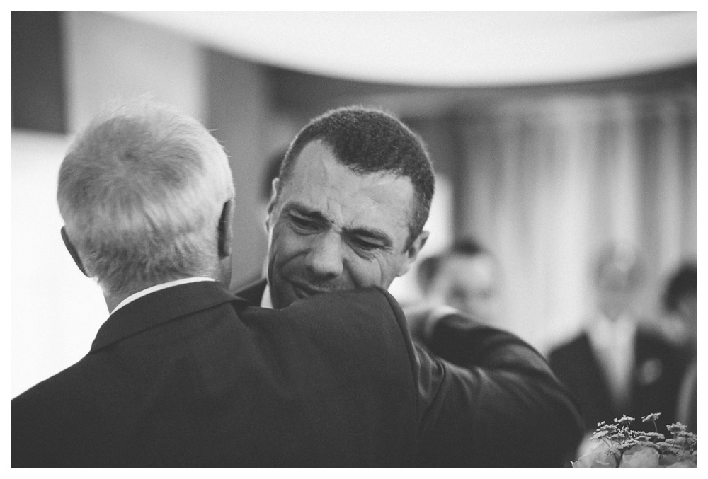 Emotional groom hugging father in law on his wedding day at the briars.