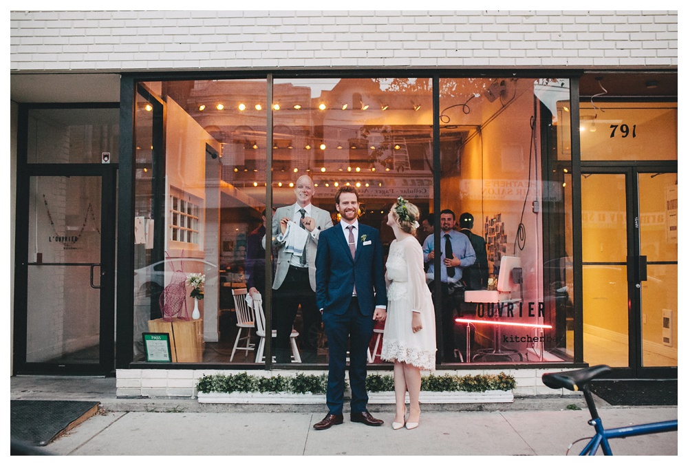 Couple hold hands outside of L'Ouvrier restaurant for their intimate wedding in Toronto.