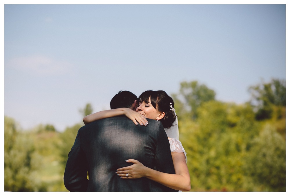 Couple embraces at Brickworks Toronto on their wedding day.