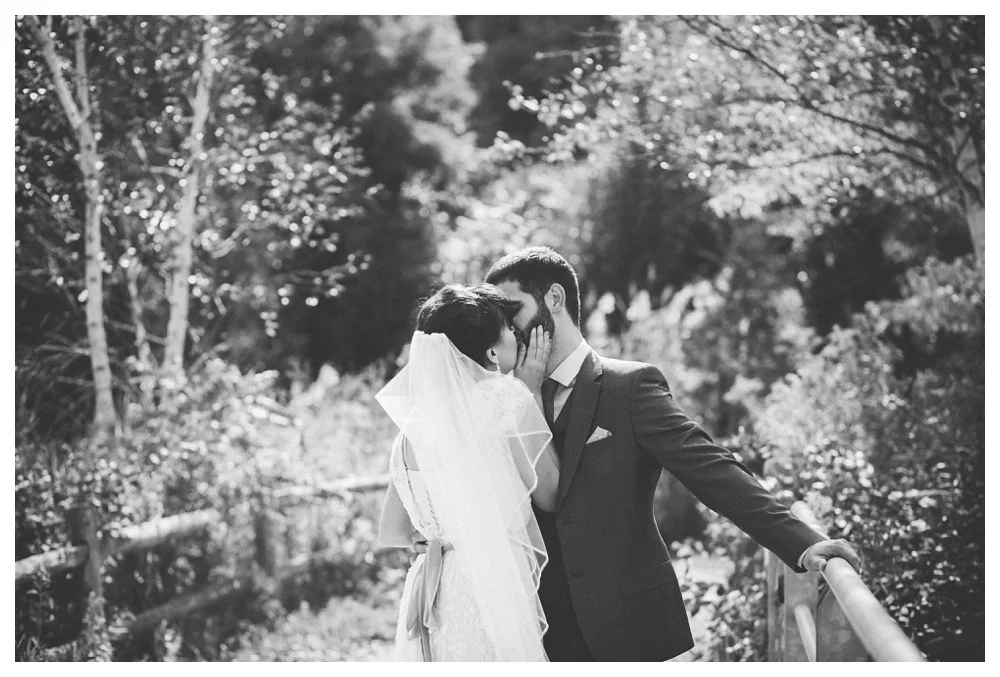 couple kiss at Evergreen Brickworks on their wedding day in Toronto.
