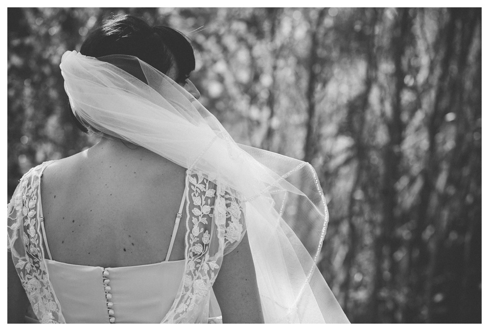 Veil blowing over brides face at a summer wedding at Brickworks, Toronto.