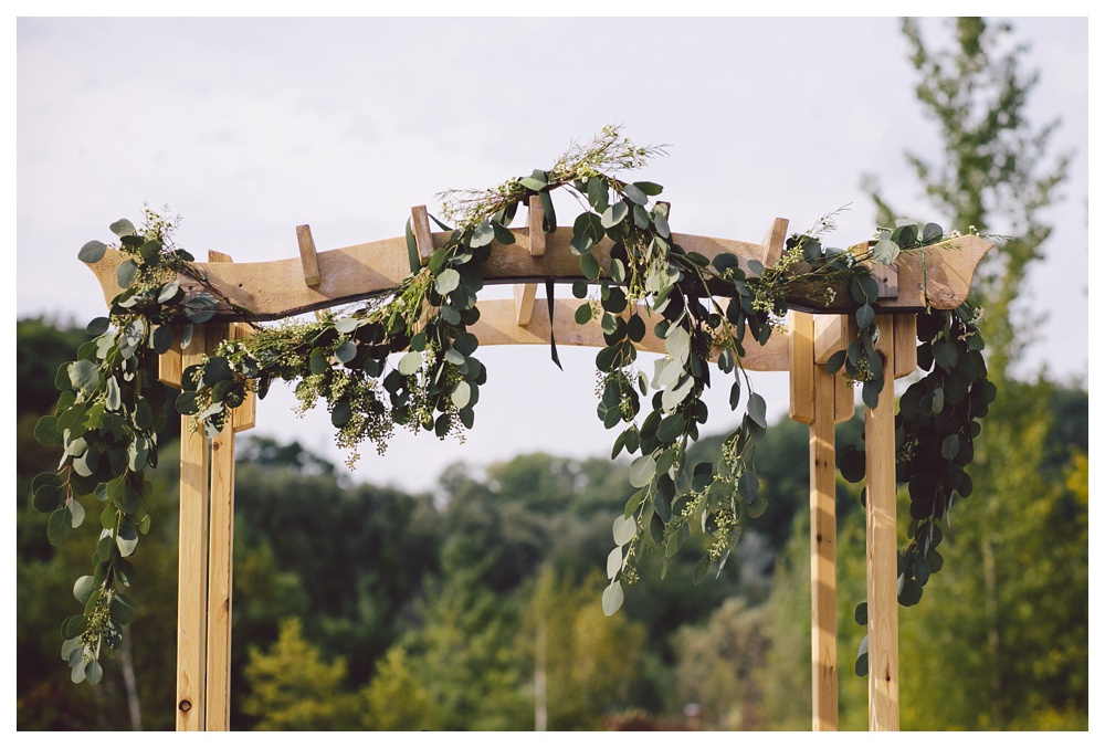 Ceremony arch with foliage at Brickworks, Toronto for a wedding.