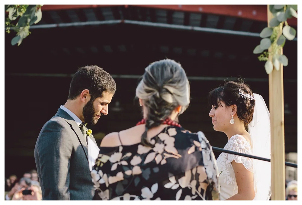 Couple saying vows during wedding ceremony at Brickworks, Toronto.