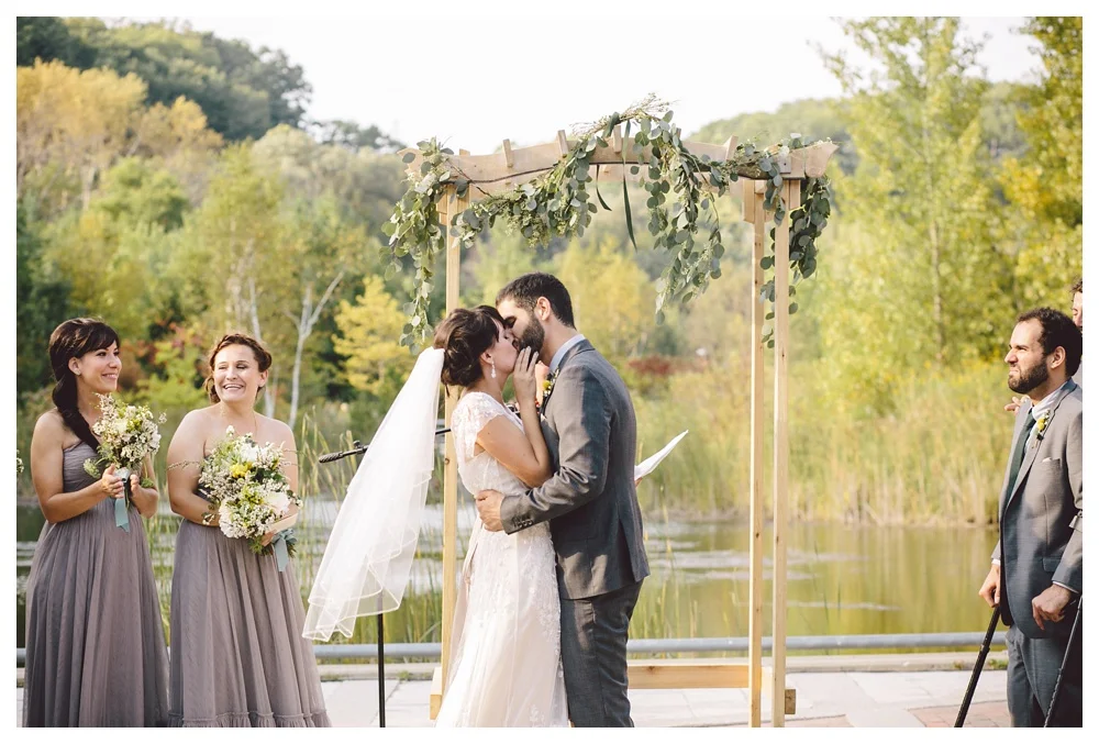 Couple kiss during wedding ceremony at Brickworks, Toronto.