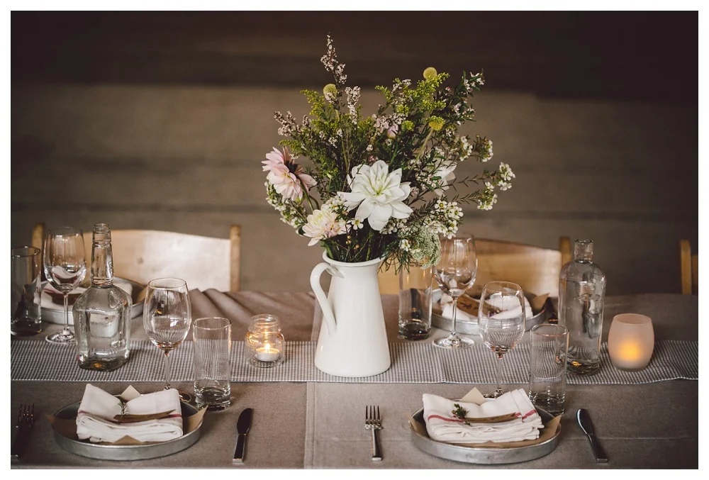 Wildflower centrepiece in a white pitcher at a Brickworks wedding, Toronto.
