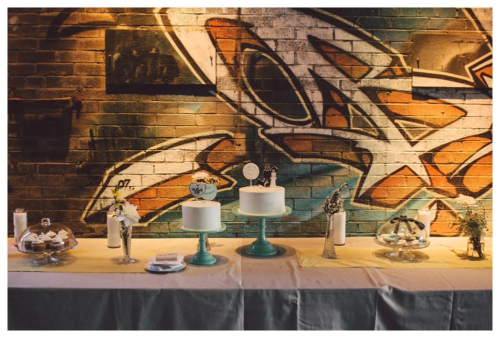 Cake display on jade green cake stands for a wedding at Brickworks.