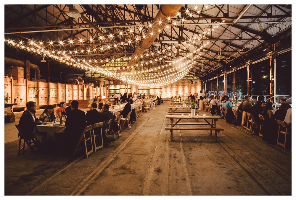 Brickworks dining room under string lights.